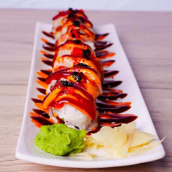 Hornbill Sushi & Asian Fusion's sushi roll with bright orange and red sauces, black and red roe, wasabi, and ginger.