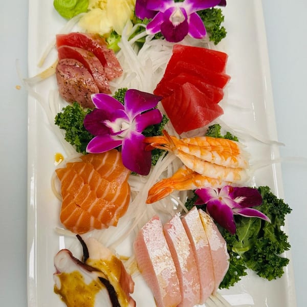 A Hornbill Sushi & Asian Fusion sashimi platter with tuna, salmon, shrimp, octopus, and white fish.