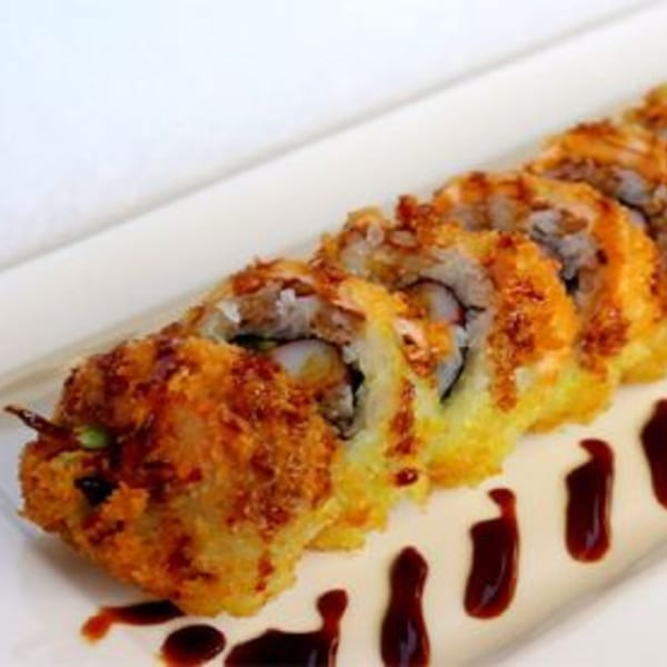 Hornbill Sushi & Asian Fusion's crispy fried sushi rolls with dark sauce on a white plate.