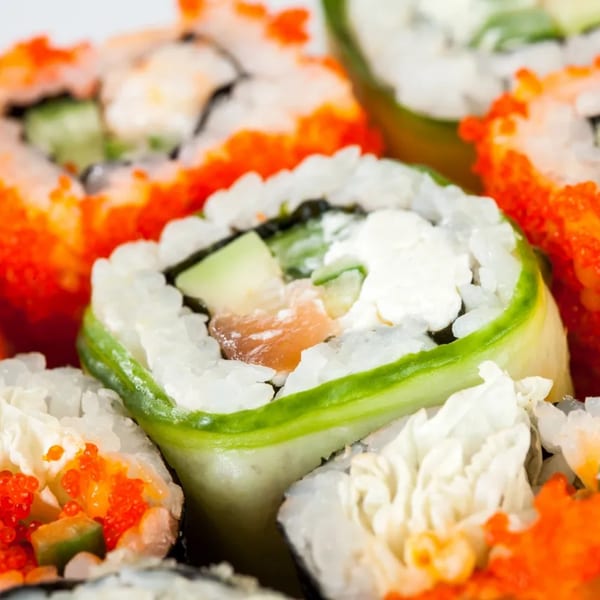 Close-up of Hornbill Sushi & Asian Fusion's colorful sushi rolls with salmon, avocado, and roe.