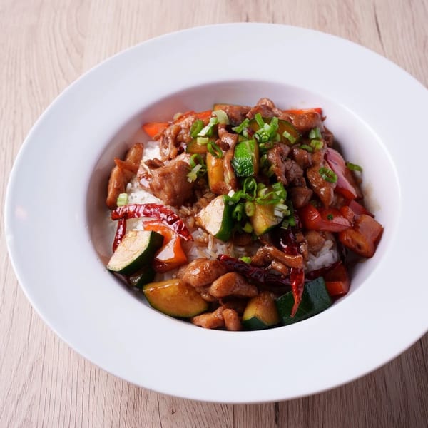 Hornbill Sushi & Asian Fusion's Kung Pao Chicken with rice, zucchini, red peppers, and scallions.